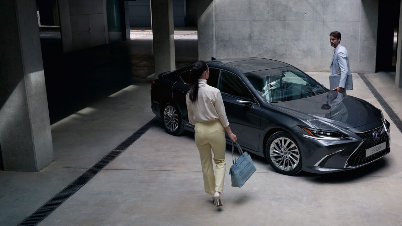Two people approaching a Lexus ES